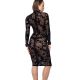 Une femme élégante portant une robe résille noire, posant dans un cadre sombre et sensuel.
